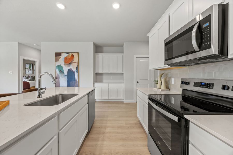 A kitchen with white cabinets. A kitchen with white cabinets.