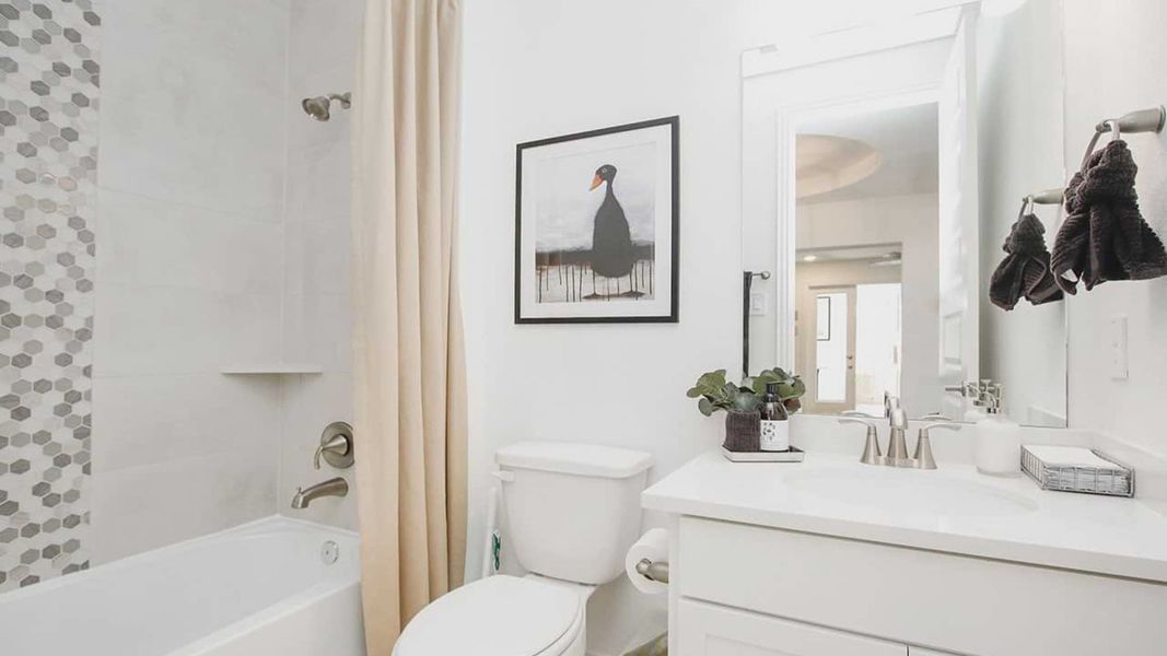 Luxurious bathroom features chic hexagonal tiles and premium fixtures in the Cypress Green community. Luxurious bathroom features chic hexagonal tiles and premium fixtures in the Cypress Green community.