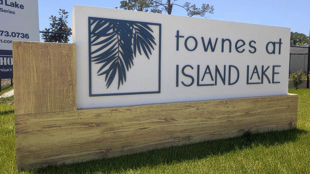 Entrance to the Townes at Island Lake community in Pinellas Park, FL, featuring signage and landscaping (Image 1).