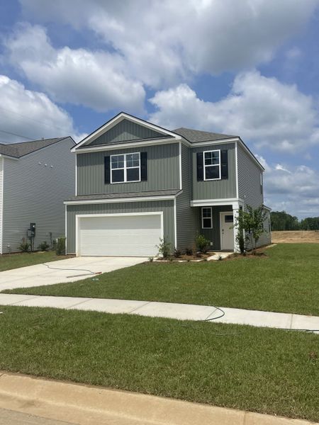 A charming gray home with a sleek two-story design and green lawn in Pineview North by D.R. Horton (Summerville, SC).