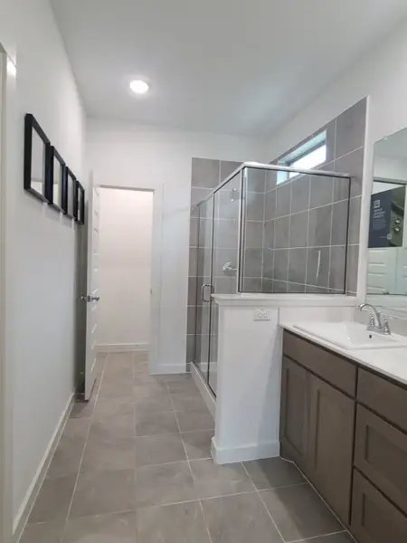 A modern bathroom featuring a glass shower, sleek tiles, and a stylish vanity with ample storage. A modern bathroom featuring a glass shower, sleek tiles, and a stylish vanity with ample storage.
