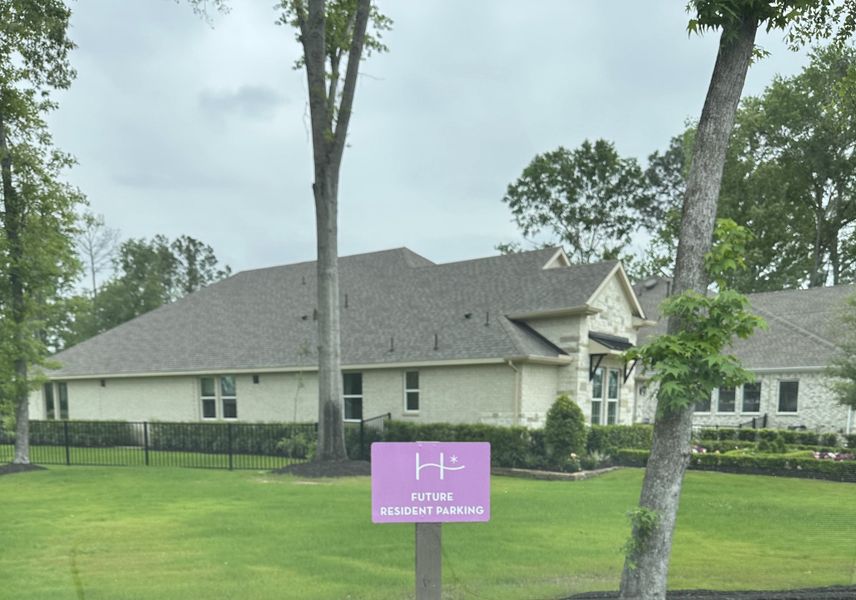 Charming brick home with elegant design and lush landscaping in The Highlands by Caldwell Homes (Porter, TX).