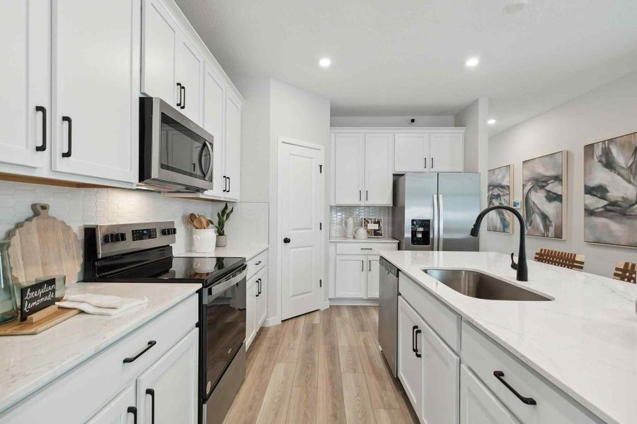 A kitchen with white cabinets. A kitchen with white cabinets.