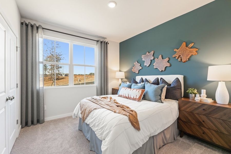 A bedroom with a bed and a window. A bedroom with a bed and a window.