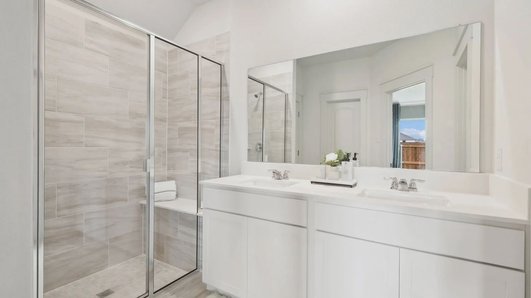 Luxurious bathroom with elegant tilework and sleek dual sinks in Still Water Lake Estates.