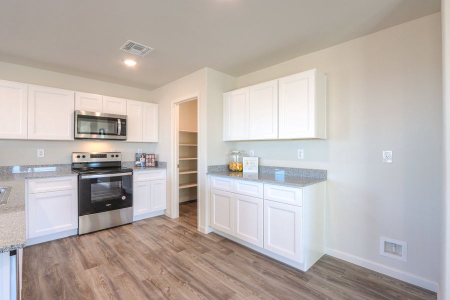 A kitchen with white cabinets. A kitchen with white cabinets.