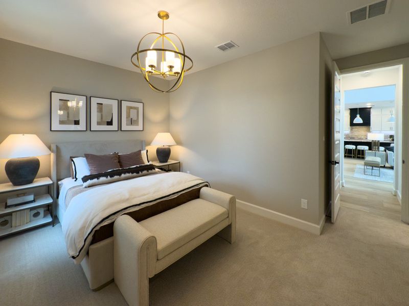 A cozy bedroom with modern lighting, neutral tones, and elegant decor, leading into a stylish, open-concept living space. A cozy bedroom with modern lighting, neutral tones, and elegant decor, leading into a stylish, open-concept living space.