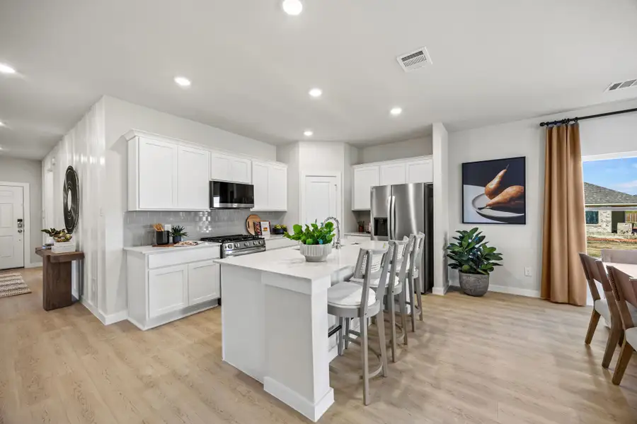 A kitchen with white cabinets.