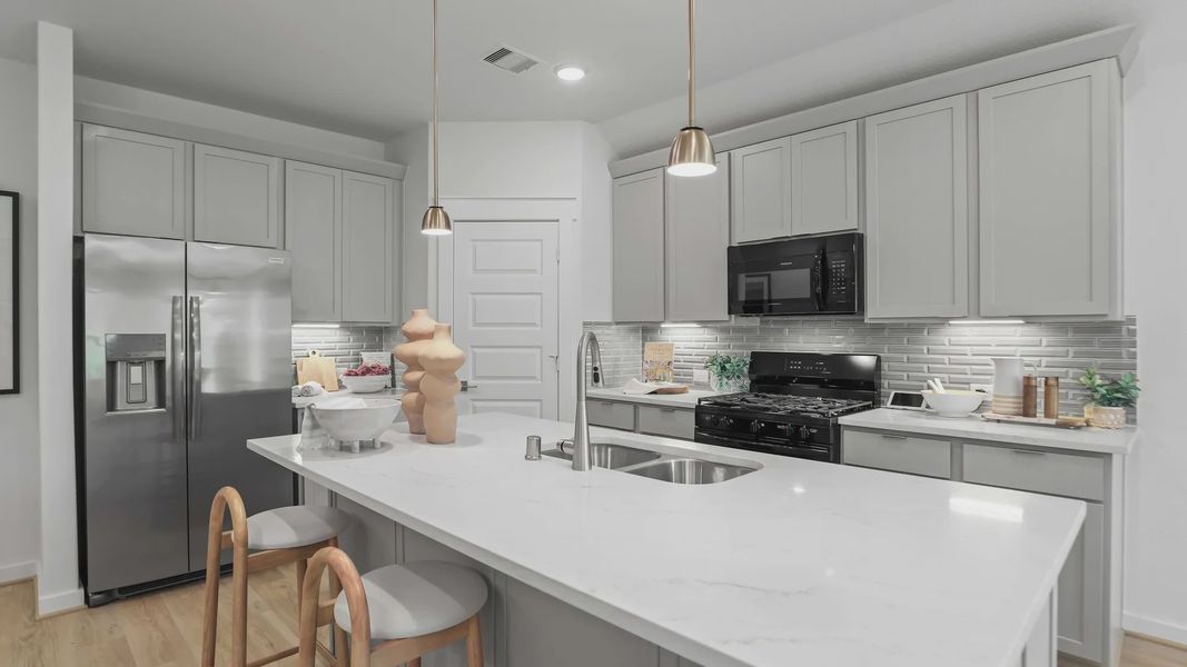 Experience luxury in Mostyn Springs with a marble kitchen island and sleek cabinetry defining elegance. Experience luxury in Mostyn Springs with a marble kitchen island and sleek cabinetry defining elegance.