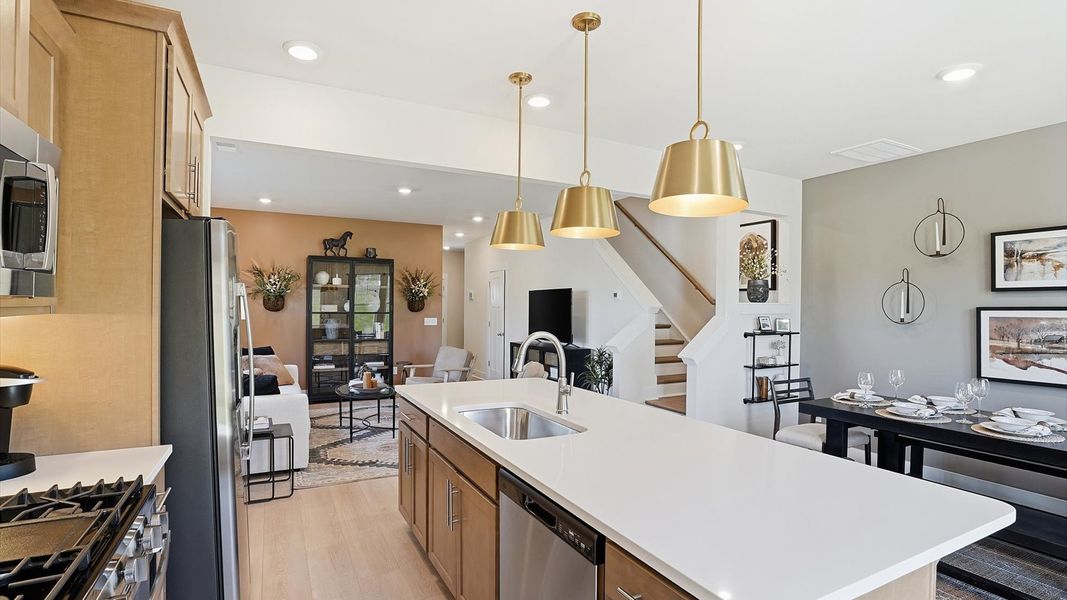Accomplished kitchen design featuring pendant lighting above a statement island for both prep and gathering