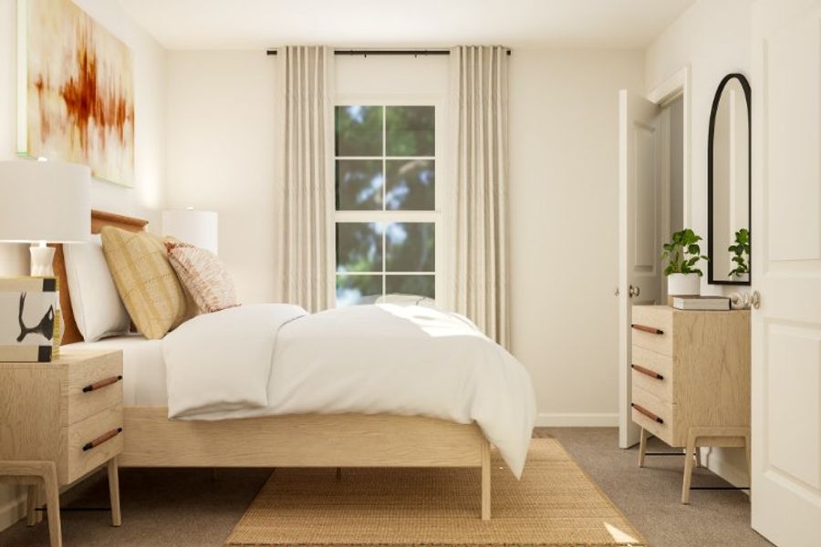 A bedroom with a bed and a dresser.