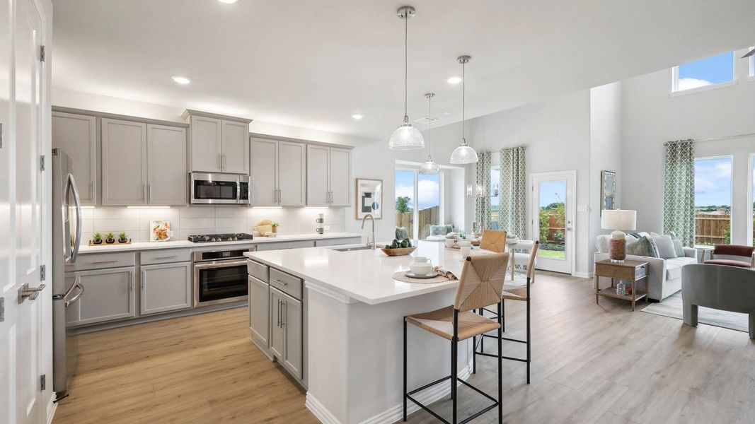Elegant light gray cabinetry and expansive island enhance this Fort Worth home's sophisticated open layout. Elegant light gray cabinetry and expansive island enhance this Fort Worth home's sophisticated open layout.