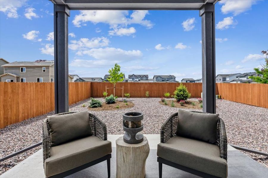 A patio with a wood fence and a patio with a wood railing.