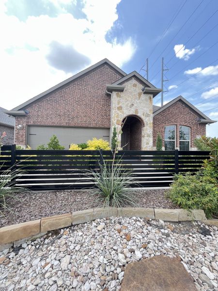 A charming brick home with stone accents and a manicured yard in Elevon by D.R. Horton (Lavon, TX). A charming brick home with stone accents and a manicured yard in Elevon by D.R. Horton (Lavon, TX).