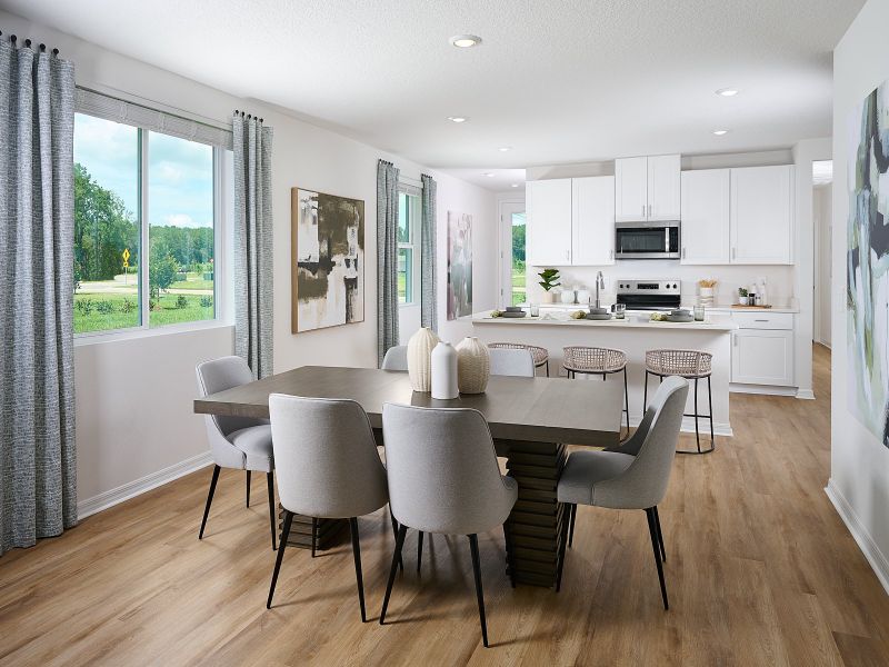 The Acadia Floorplan Dining Area Modeled at Leyland Preserve.