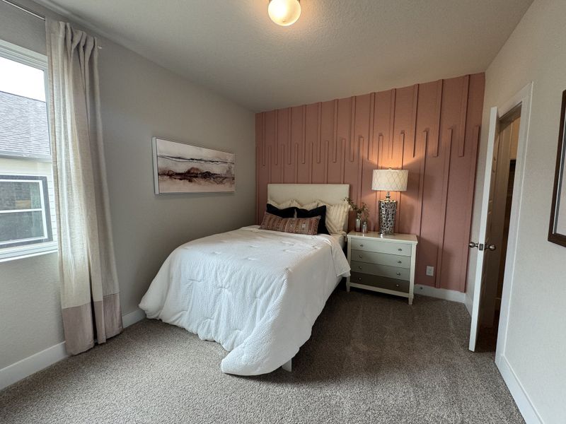 A cozy bedroom with a textured pink accent wall, soft lighting, and elegant white bedding. A cozy bedroom with a textured pink accent wall, soft lighting, and elegant white bedding.