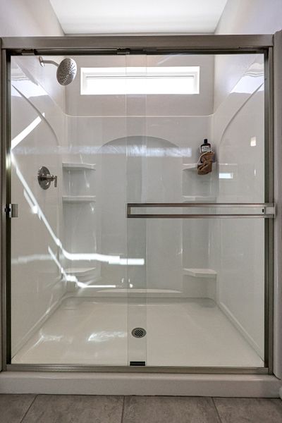 A shower with a glass door. A shower with a glass door.
