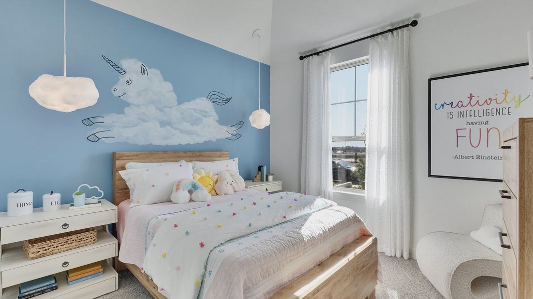 Delightful unicorn mural and plush bedding enhance this Briarwood bedroom’s whimsical charm.
