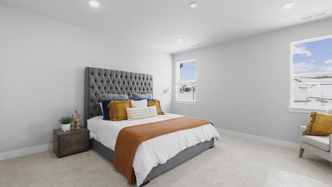 Experience serene comfort with a tufted headboard, plush carpeting, and abundant natural light in Montaine.