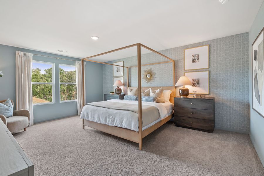 A bedroom with a large mirror.