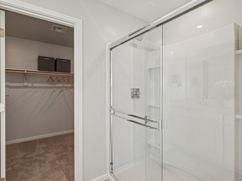 A shower with glass doors.