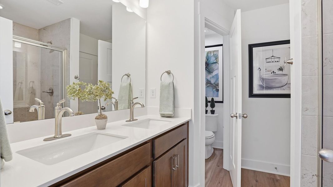 Notable primary bath featuring dual vanity, walk-in shower, and tasteful design touches throughout at Marion Square