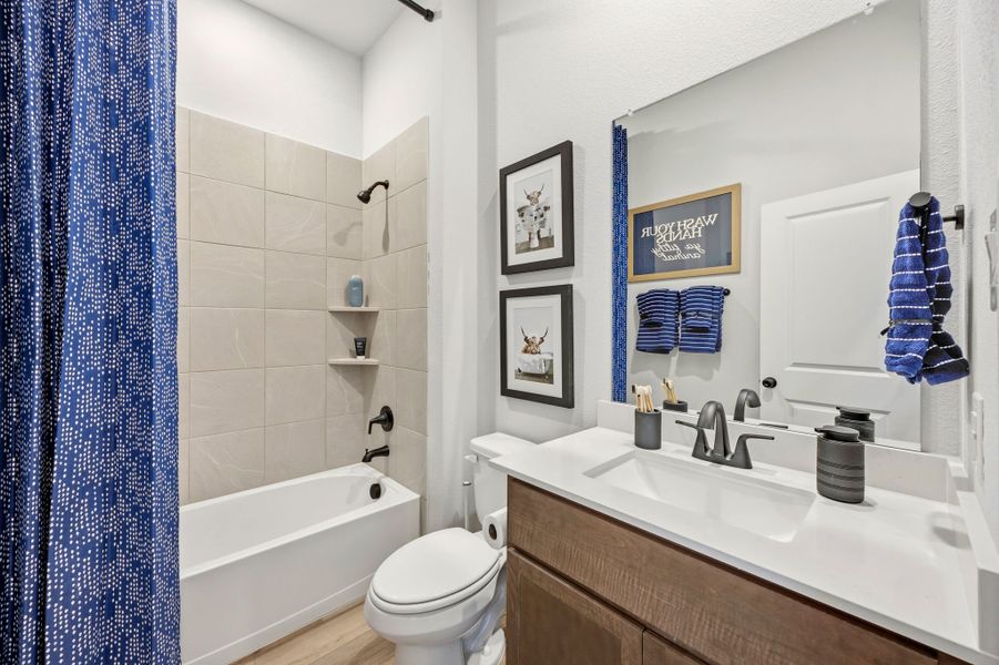 A bathroom with a tub sink and toilet. A bathroom with a tub sink and toilet.