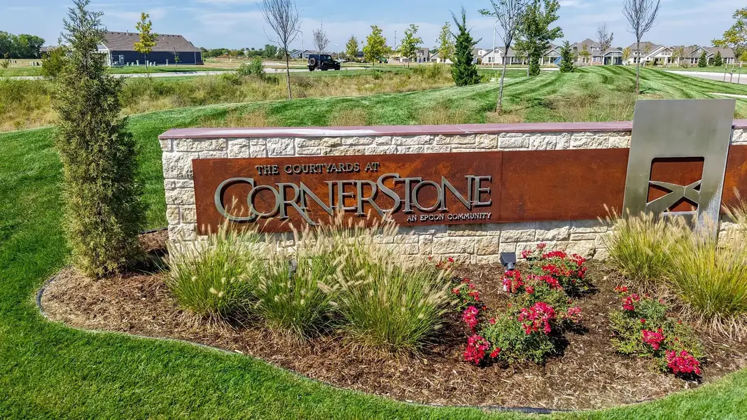 Entrance to the The Courtyards at Cornerstone community in Andover, KS, featuring signage and landscaping (Image 2). Entrance to the The Courtyards at Cornerstone community in Andover, KS, featuring signage and landscaping (Image 2).