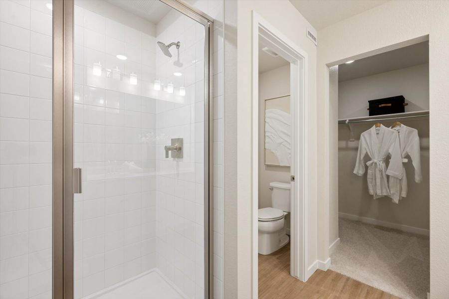 A bathroom with a glass shower. A bathroom with a glass shower.