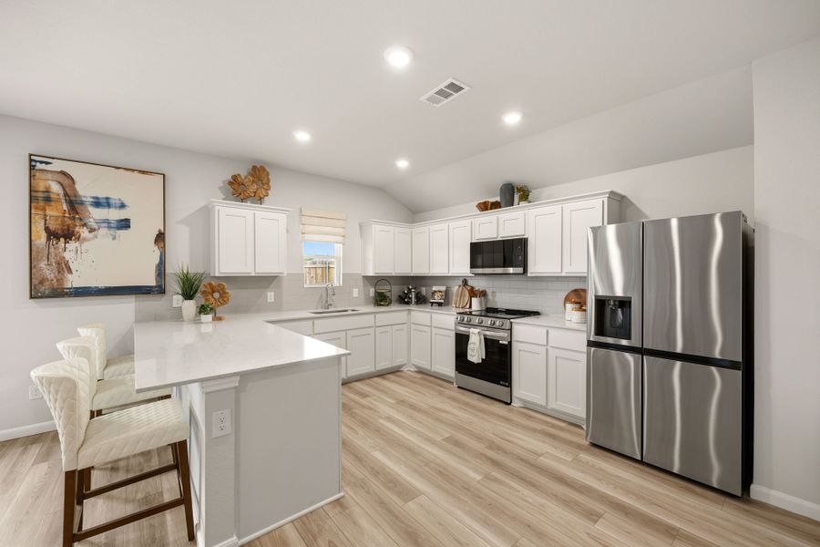 A kitchen with white cabinets. A kitchen with white cabinets.