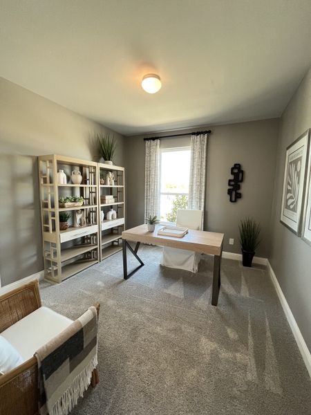A cozy home office with a sleek wooden desk, modern shelving, and neutral-toned decor for a calming workspace. A cozy home office with a sleek wooden desk, modern shelving, and neutral-toned decor for a calming workspace.