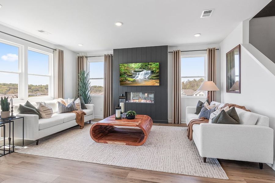 A living room with a large window. A living room with a large window.