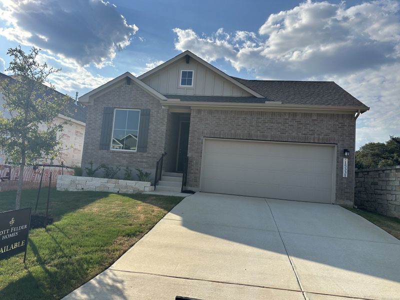 A modern brick home with a neat lawn in Park Hill Commons by Scott Felder Homes, San Antonio, TX.