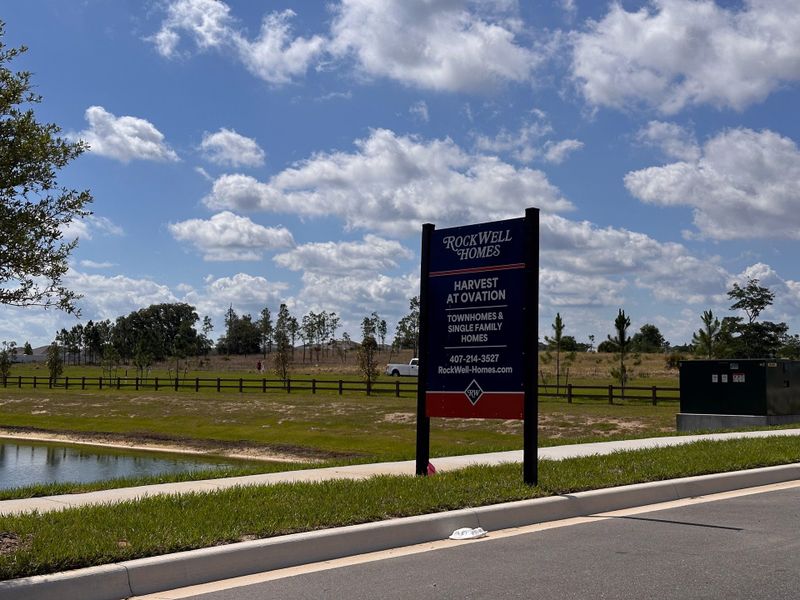 A serene landscape view in Harvest at Ovation by Rockwell Homes, Winter Garden, FL, featuring open fields and clear skies. A serene landscape view in Harvest at Ovation by Rockwell Homes, Winter Garden, FL, featuring open fields and clear skies.