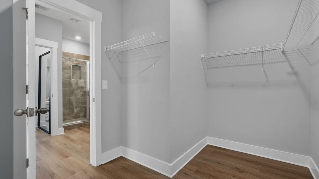 Spacious walk in closet inside en suite primary bathroom at Barton Hollow by DRB Homes in Fountain Inn, SC