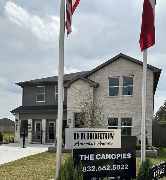 A modern brick home with bold design elements and a manicured lawn in The Canopies by D.R. Horton (Splendora, TX). A modern brick home with bold design elements and a manicured lawn in The Canopies by D.R. Horton (Splendora, TX).