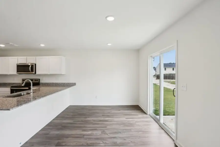 A kitchen with a large glass door.