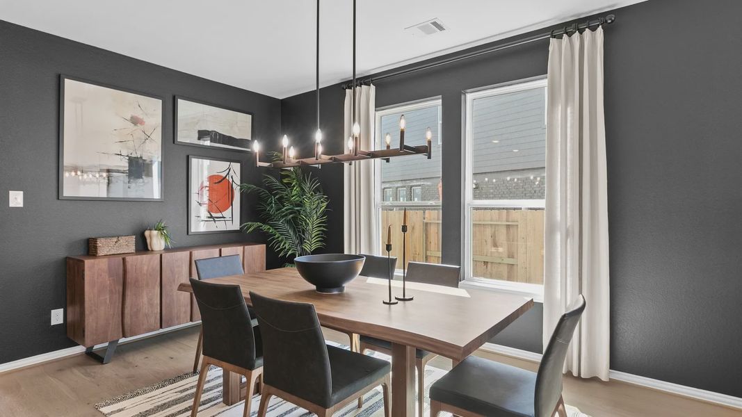 Exquisite dark accent wall highlights contemporary chandelier and wood finishes in River Ranch. Exquisite dark accent wall highlights contemporary chandelier and wood finishes in River Ranch.