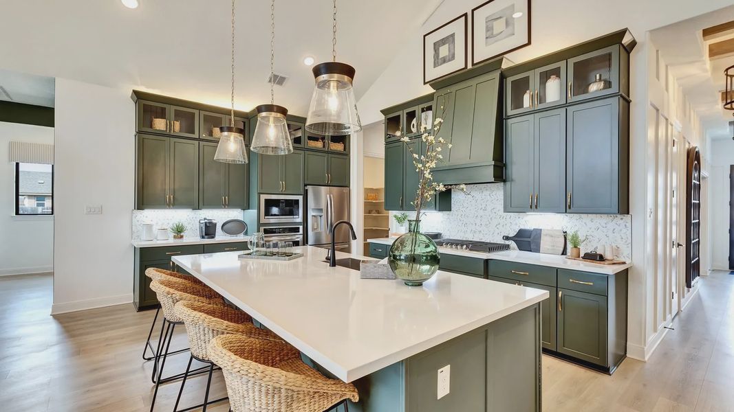 This stunning kitchen showcases ceiling-height cabinetry, spacious oversized island, and designer pendant lighting This stunning kitchen showcases ceiling-height cabinetry, spacious oversized island, and designer pendant lighting