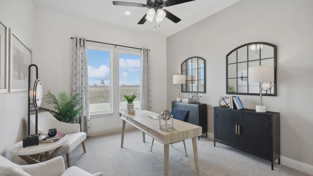 Elegant study with panoramic windows, chic furnishings, and modern lighting in Westside Preserve.