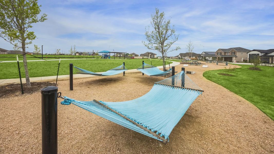 Embrace tranquility with elegant hammocks amidst lush greenery in Carillon community's upscale park. Embrace tranquility with elegant hammocks amidst lush greenery in Carillon community's upscale park.