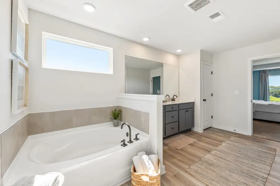 A bathroom with a tub and sink.