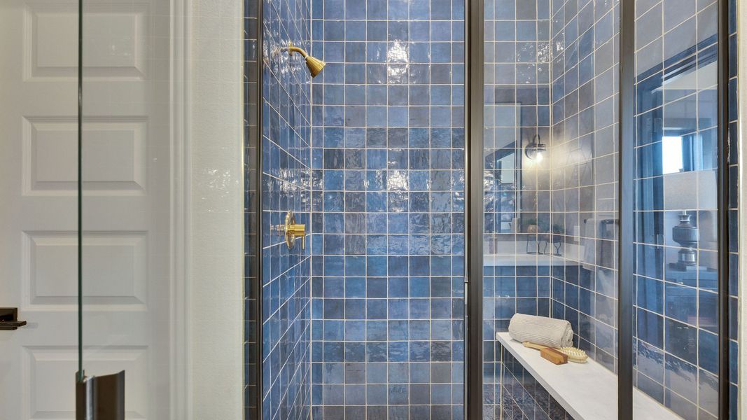 Indulge in this sophisticated shower with exquisite blue tiles and brass details in Lakeside Meadows. Indulge in this sophisticated shower with exquisite blue tiles and brass details in Lakeside Meadows.