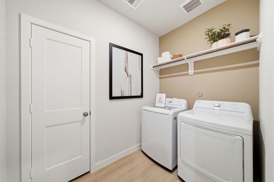 A room with a washer and dryer.