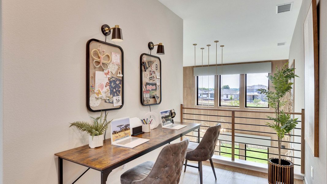 Sleek desk, chic lighting, and expansive windows embody refined living in Lakeside Meadows. Sleek desk, chic lighting, and expansive windows embody refined living in Lakeside Meadows.