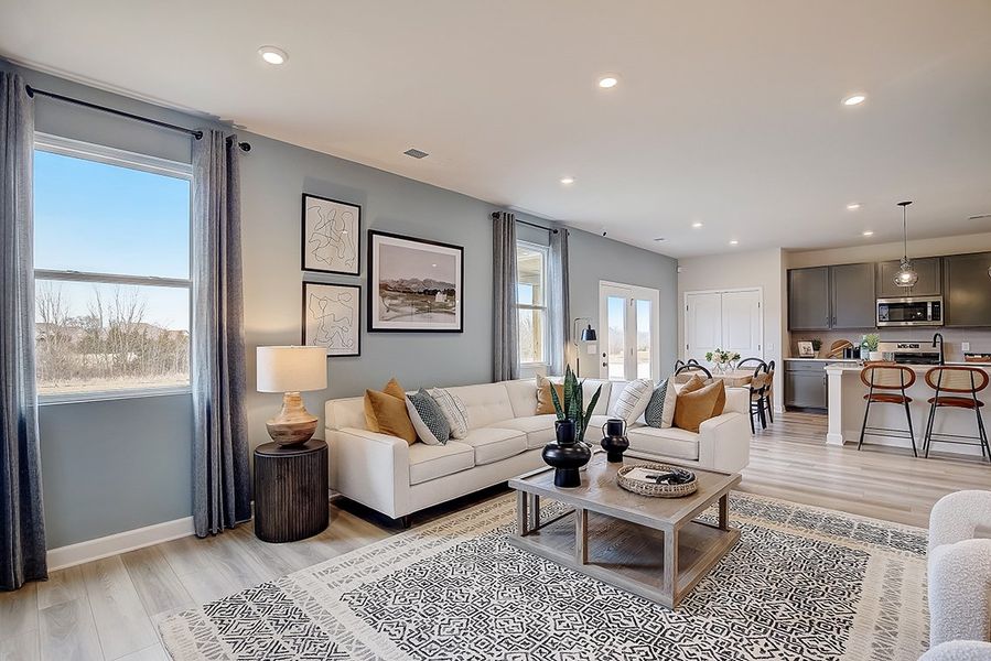 A living room with a large window. A living room with a large window.