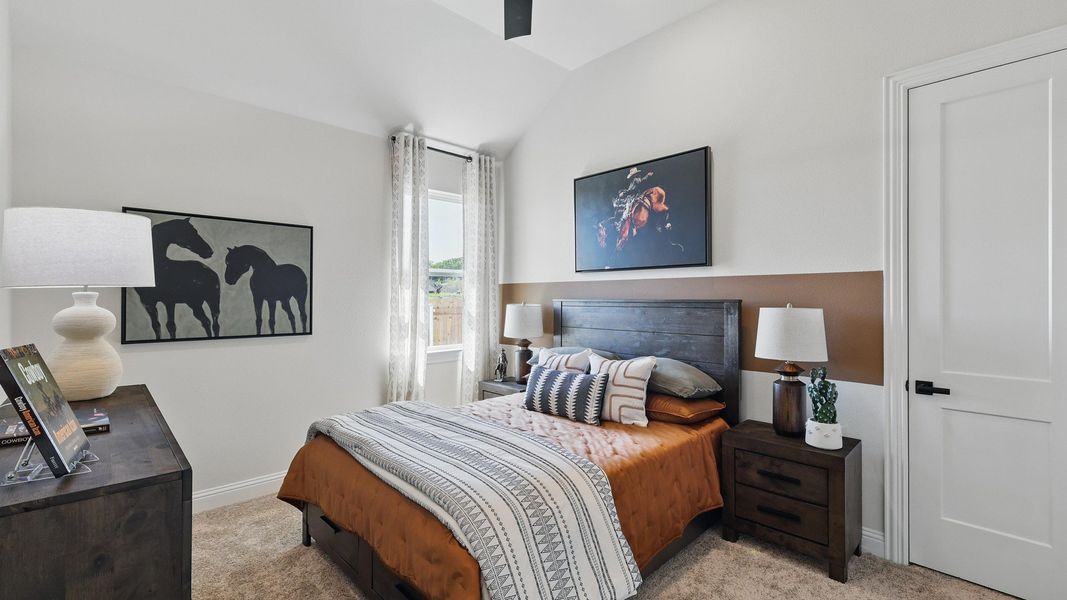 Experience vaulted ceilings and tasteful horse artwork in this refined Green Oaks Preserve bedroom. Experience vaulted ceilings and tasteful horse artwork in this refined Green Oaks Preserve bedroom.