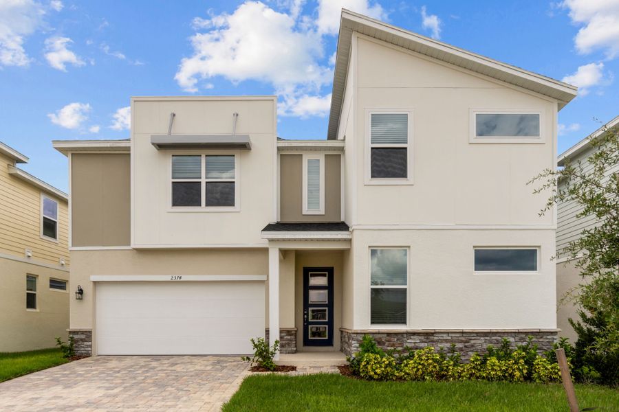 Front exterior of a home in the Solara Resort community, located in Kissimmee, FL (Image 13).