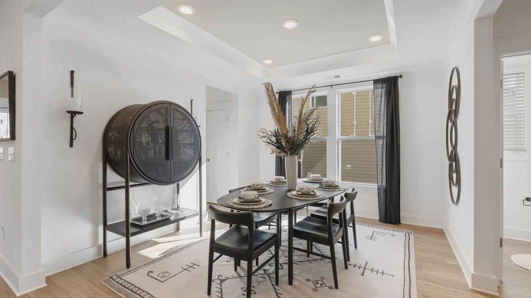 Black and white modern dining room with hardwood flooring and luxury vaulted ceiling detail at Magnolia Park by DRB Homes Black and white modern dining room with hardwood flooring and luxury vaulted ceiling detail at Magnolia Park by DRB Homes