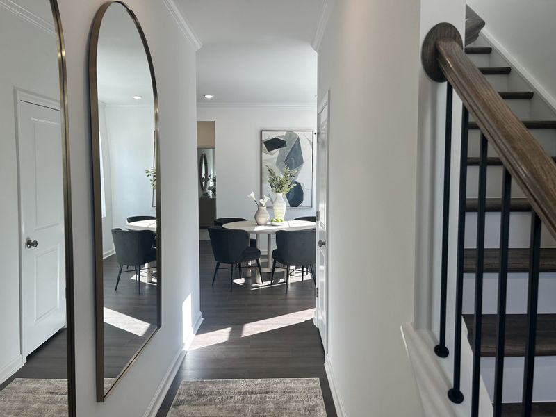 A carpeted staircase with a black railing leading to the second floor in Sherri Downs by Lennar (Angier, NC).